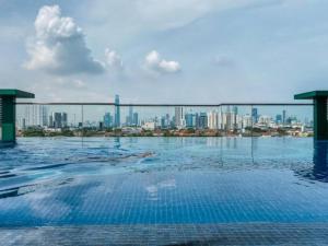 a swimming pool with a city skyline in the background at Ampang 2-4 pax Studio AmpPoint in Ampang