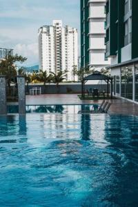 a large swimming pool in a city with tall buildings at Ampang 2-4 pax Studio AmpPoint in Ampang