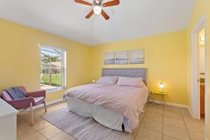 a bedroom with a bed and a ceiling fan at Gilded Parasol by Shine Villas Remington Golf #410 home in Kissimmee +33 photos