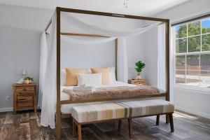 a bedroom with a canopy bed and a window at 3 King Bedrooms - Beautiful New Port Richey in New Port Richey