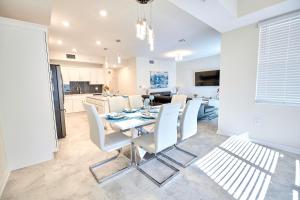 a dining room and kitchen with a table and chairs at Vacation Meadows - Storey Lake by Shine Villas 710 apts in Kissimmee