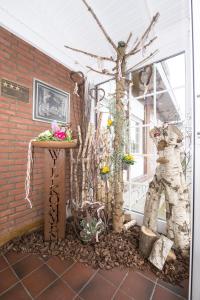 a patio with a table with flowers and a tree at Land-gut-Hotel Rohdenburg in Lilienthal