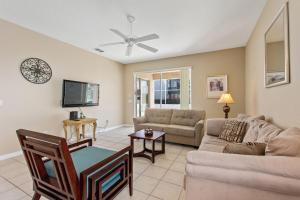 a living room with a couch and a tv at Sun Living- Golf Community, Private Pool 809 villa in Davenport