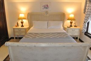 a bedroom with a white bed with two night stands at Cozy Cape Cod Vacation House in Two Rivers in Two Rivers