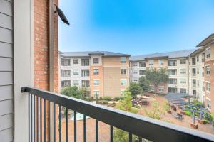 a balcony with a view of a park and buildings at Beautiful 1Br/NRG/Pool/Wi-Fi/PetsOK/Garage parking in Houston