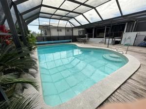 a large blue swimming pool with a roof at Seacrest on Bright in Emu Park