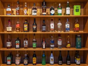 a shelf filled with lots of bottles of alcohol at Elan Hotel Lake Nojiri in Shinano