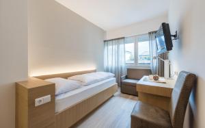 Posteľ alebo postele v izbe v ubytovaní Hotel Post Gries