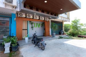 a motorcycle parked in front of a building at Urbanview Hotel R House Batam in Jabi