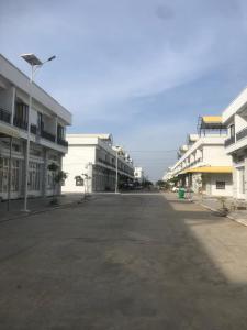 an empty street in a city with white buildings at Your living & working sanctuary near Phnom Penh in Phumĭ Kândal (2)