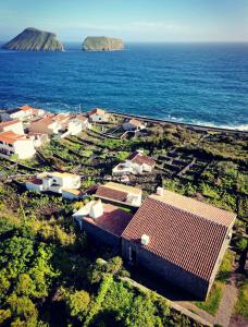an aerial view of a village and the ocean at Breathe Nature - Beach House Azores in Feteira