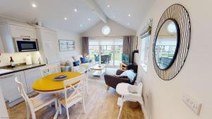 a kitchen and living room with a table and a mirror at Bay Breeze - Part of the The Bay Filey Holiday Village with pool, gym and direct beach access, pub, restaurant, tennis and meadows walks in Filey