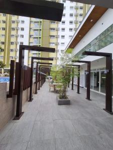 a walkway in a building with benches and buildings at Studio unit at Mesaverte Residence in Cagayan de Oro