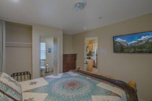 1 dormitorio con 1 cama y una pintura en la pared en Cozy Cub Cabin, brand new home near Yosemite, en Mariposa