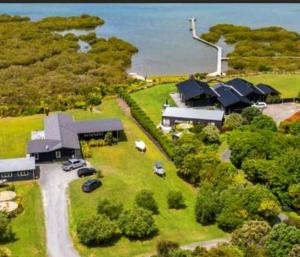 an aerial view of a large house with a yard at Peace and Aroha Mangawhai - Apartment in Mangawhai