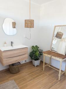 a bathroom with a sink and a mirror and a table at La Posada Coliving in Viña del Mar