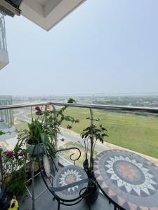 a balcony with chairs and a view of a field at Amy Apartment in Nera Garden Hue in Thôn Văn Dương