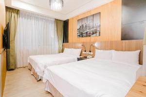 Postel nebo postele na pokoji v ubytování Royal Rose Hotel Ximen