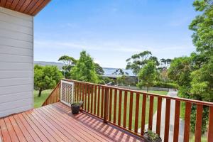 a wooden deck with a view of the water at Too Tyred - Binalong Bay in Binalong Bay