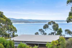 a house with a view of a body of water at Too Tyred - Binalong Bay in Binalong Bay