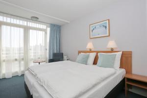 Een bed of bedden in een kamer bij Hotel Golfzicht