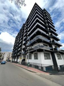 a large apartment building on the side of a street at City Center Sunny Apartment in Suceava