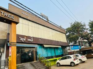 two white cars parked in front of a building at The Jamun Tree in Muzaffarpur