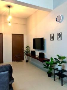 a living room with a flat screen tv on the wall at Blue House｜Ulu Yam Homestay｜12-15pax in Batang Kali