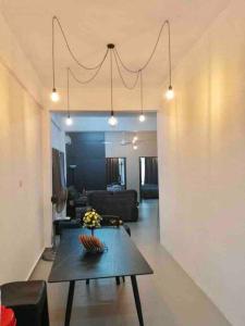 a living room with a table and a couch at Blue House｜Ulu Yam Homestay｜12-15pax in Batang Kali +16 photos