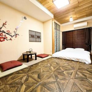 a bedroom with a bed and a table in a room at ueno minowa401 in Tokyo