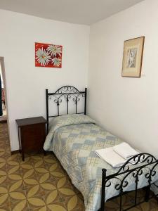 a bedroom with a bed and a table and a picture at Trullo La Quercia in Ostuni