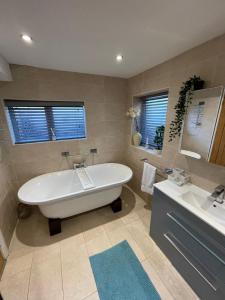 a large bathroom with a tub and a sink at Luxury Accomodation close to city centre in Plymouth