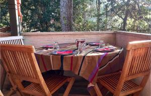 a table with plates and glasses on top of it at Lovely Home In Lignano Sabbiadoro in Lignano Sabbiadoro