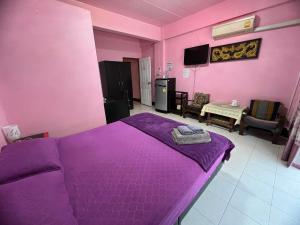 a bedroom with a purple bed in a room at Sötnos in Jomtien Beach