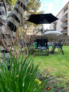 a patio with two chairs and an umbrella at Willa Retro Hostel in Krakow