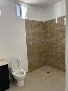 a bathroom with a toilet and a shower at TWO bedroom apartment 101 in Mazatlán