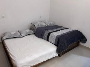 a small bedroom with a bed in a room at TWO bedroom apartment 101 in Mazatlán