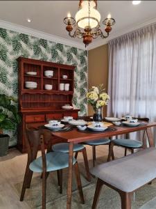 a dining room with a wooden table and chairs at Casablanca Holiday Home with BBQ Pit in Kuching