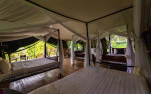a bedroom with two beds in a tent at Ngorongoro Wild Camp in Ngorongoro