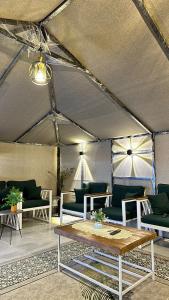 a room with couches and a table in a tent at استراحة دار العين in Al Ain