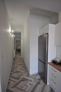 a hallway leading to a kitchen with a refrigerator at Apartments Chania in Chania Town