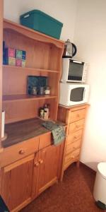 a kitchen with a microwave and a counter top at Appartement cosy cœur de station in Villard-de-Lans