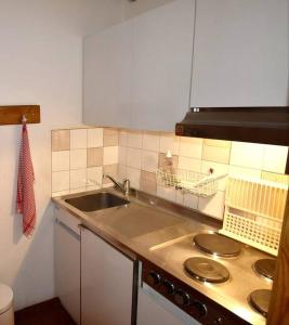 a kitchen with a sink and a counter top at Appartement cosy cœur de station in Villard-de-Lans
