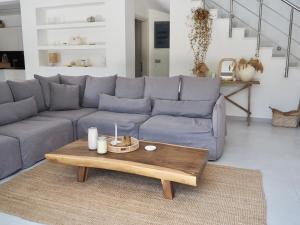 a living room with a blue couch and a coffee table at Luxury Getaway in Zante-Eliá Luxury Villas in Akrotiri