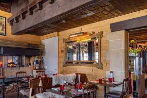 a restaurant with tables and chairs and a mirror at Le Coucou Hotel Restaurant & Lounge-Bar in Montreux