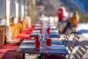 a row of tables with wine glasses on them at Le Coucou Hotel Restaurant & Lounge-Bar in Montreux