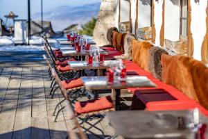 a row of tables with red seats on a patio at Le Coucou Hotel Restaurant & Lounge-Bar in Montreux