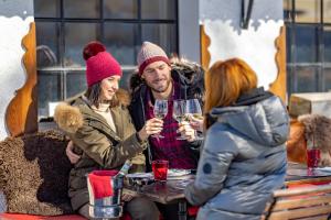 a group of people sitting around a table with wine glasses at Le Coucou Hotel Restaurant & Lounge-Bar in Montreux
