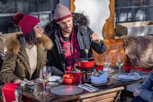 a man and woman sitting at a table with a cake at Le Coucou Hotel Restaurant & Lounge-Bar in Montreux