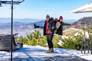a man and a woman standing in the snow at Le Coucou Hotel Restaurant & Lounge-Bar in Montreux